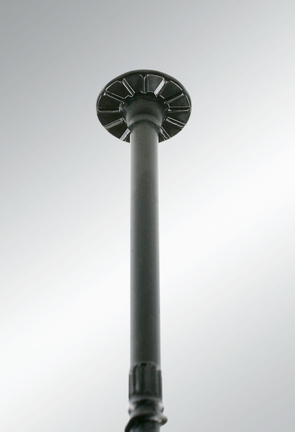 Low-angle view of the round nibbed head of a Simpson Strong-Tie SDW structural wood screw