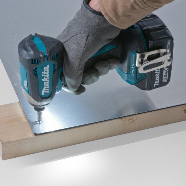 Makita 18V impact driver used with gloves to fasten sheet metal to wood