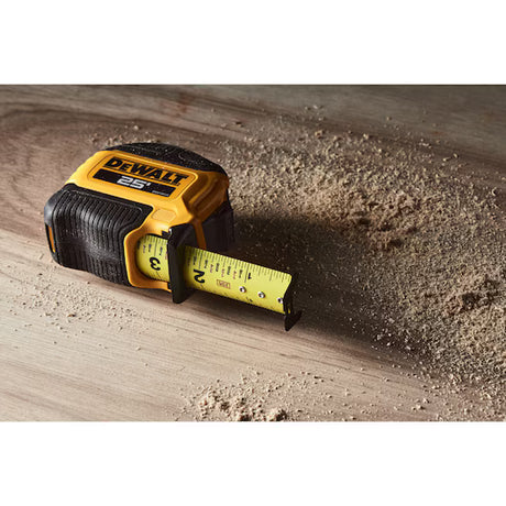 DeWalt 25 ft tape measure extended on a sawdust-covered wood surface